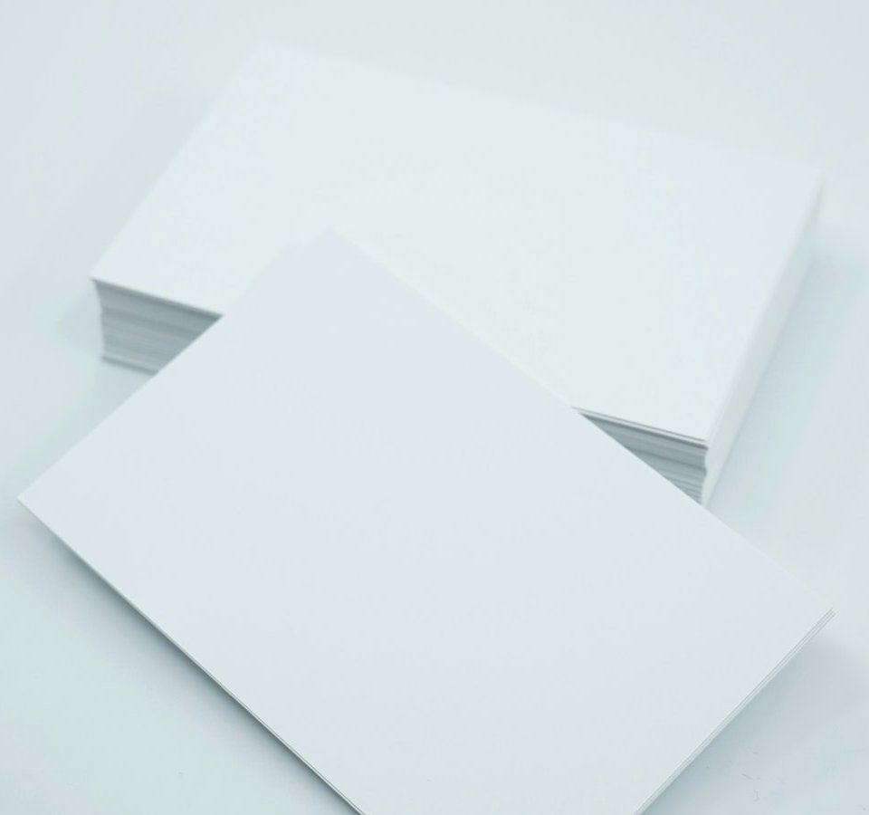 Stacks of blank business cards ready for print.